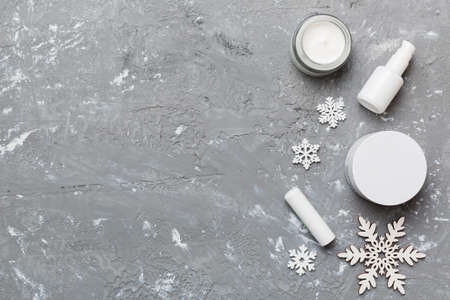 Makeup products and Christmas decorations on color background. Top view New year Beauty concept with copy space.の写真素材