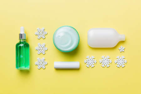 Makeup products and Christmas decorations on color background. Top view New year Beauty concept.
