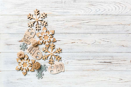 Flat composition with a Christmas tree made of different festive items, snowflakes, gifts, sweets on a white background. Copy space.の写真素材