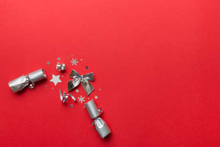 Christmas crackers with shiny confetti on color background, top view, copy space.の写真素材