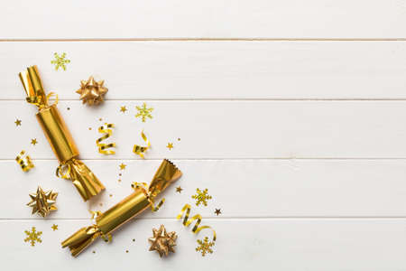 Christmas crackers with shiny confetti on color background, top view, copy space.の写真素材