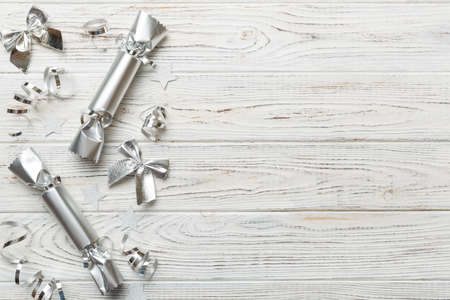 Christmas crackers with shiny confetti on color background, top view, copy space.の写真素材