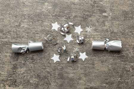 Christmas crackers with shiny confetti on color background, top view, copy space.の写真素材