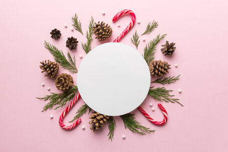 Flat lay Christmas composition. Round Paper blank, pine tree branches, christmas decorations on...