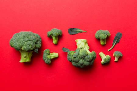 green fresh broccoli background close up on colored table. Vegetables for diet and healthy eating....