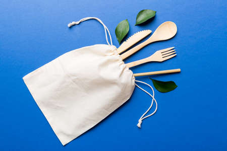 Eco friendly reusable recyclable white eco bag with kitchenware on Colored background. Concept zero waste.の写真素材