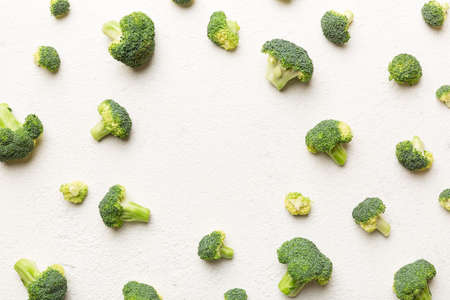 Flat lay composition with fresh green broccoli frame eith copy space on light background.の写真素材
