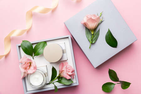 Composition with cosmetic products and beautiful roses on color background. Flat lay.の写真素材