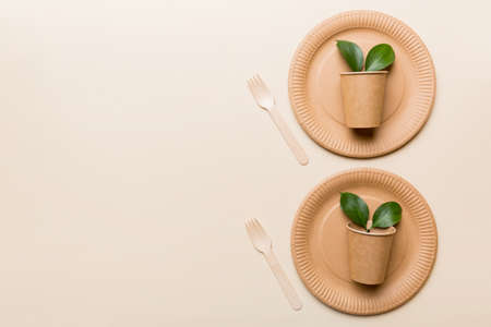 set of empty reusable disposable eco-friendly plates, cups, utensils on light white colored table background. top view. Biodegradable craft dishes. Recycling concept. Close-up.の写真素材