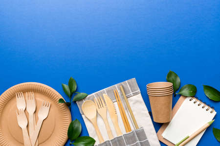 set of empty reusable disposable eco-friendly plates, cups, utensils on light white colored table background. top view. Biodegradable craft dishes. Recycling concept. Close-up.の写真素材