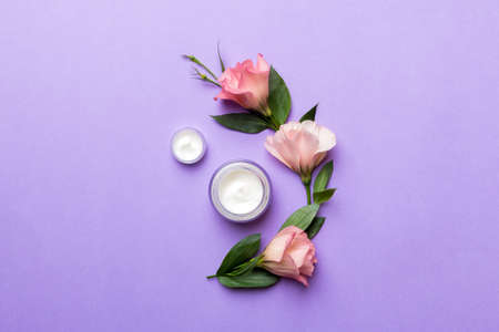Composition with cosmetic products and beautiful roses on color background. Flat lay.の写真素材