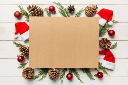 Flat lay Christmas composition. square Paper blank, pine tree branches, christmas decorations on...