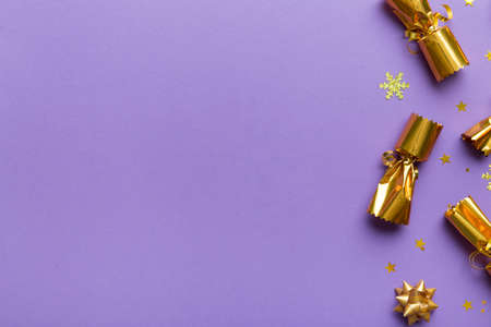 Christmas crackers with shiny confetti on color background, top view, copy space.の写真素材