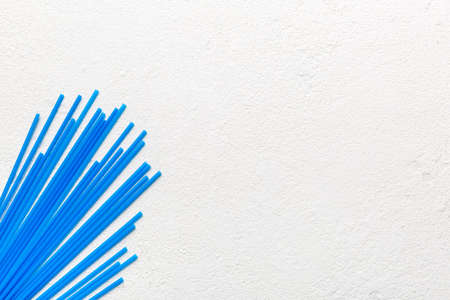 Heap of colorful plastic drinking straws on Colored background, flat lay. Copy Space for text.の写真素材