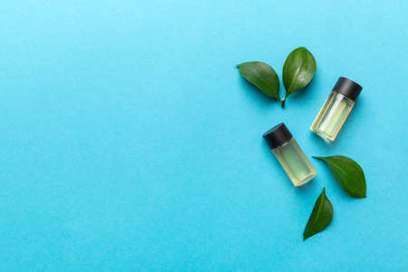 Organic cosmetic products with green leaves on color background. Copy space, flat lay.の写真素材