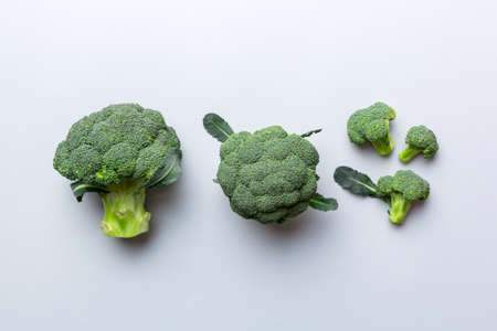 green fresh broccoli background close up on colored table. Vegetables for diet and healthy eating. Organic food.の写真素材