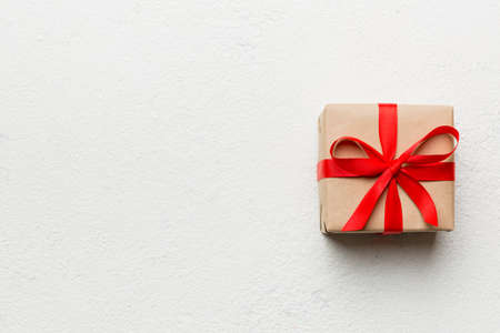 Valentine day composition: red gift box with bow and heart. Christmas present. View from above....