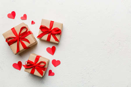 Valentine day composition: red gift box with bow and heart. Christmas present. View from above. Space for text. Holday greeting card.の写真素材