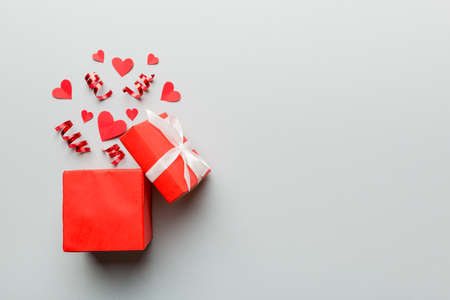 Happy valentines day opened heart shape gift box with small hearts, on colored background, valentines day card - top view concept.の写真素材