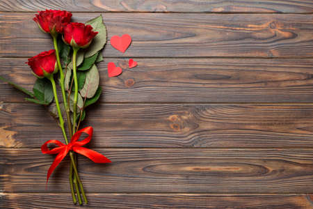 Valentine day composition with rose flower and red heart on table. Top view, flat lay, copy space Holiday concept.の写真素材
