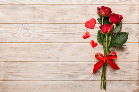 Valentine day composition with rose flower and red heart on table. Top view, flat lay, copy space Holiday concept.の写真素材