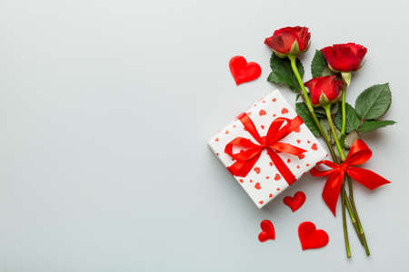 Valentine's day composition with rose flower, red heart and gift boxes on table. mother day and birthday greeting, copy space, top view.の写真素材