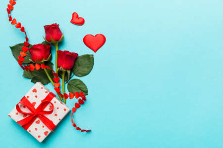 Valentine's day composition with rose flower, red heart and gift boxes on table. mother day and birthday greeting, copy space, top view.の写真素材