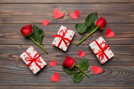 Kraft Gift box with beautiful red ribbon and rose, concept of Valentine day, anniversary, mother day and birthday greeting, copy space, top view.の写真素材