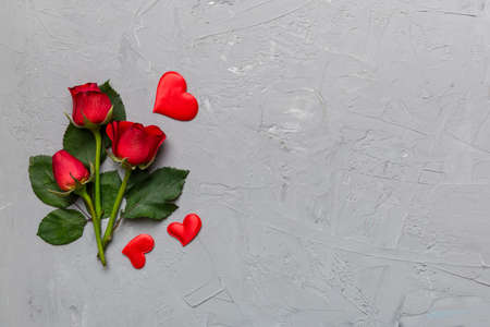 Valentine day composition with rose flower and red heart on table. Top view, flat lay, copy space Holiday concept.の写真素材
