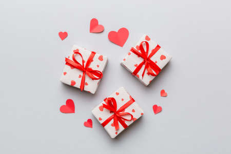 Valentine day composition Background: red gift box with bow and heart. Christmas present. View from above. Holday greeting card.の写真素材