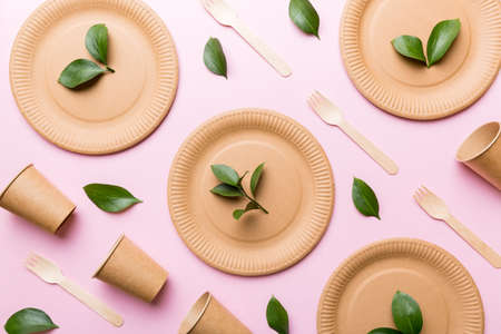 set of empty reusable disposable eco-friendly plates, cups, utensils on light white colored table background. top view. Biodegradable craft dishes. Recycling concept. Close-up.の写真素材