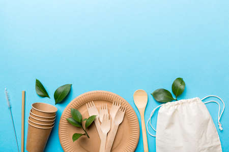 set of empty reusable disposable eco-friendly plates, cups, utensils on light white colored table background. top view. Biodegradable craft dishes. Recycling concept. Close-up.の写真素材
