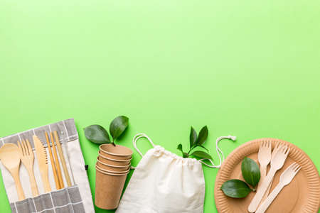 set of empty reusable disposable eco-friendly plates, cups, utensils on light white colored table background. top view. Biodegradable craft dishes. Recycling concept. Close-up.の写真素材