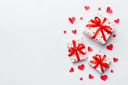 Valentine day composition: red gift box with bow and heart. Christmas present. View from above. Space for text. Holday greeting card.の写真素材