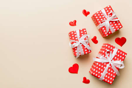 Valentine day composition: red gift box with bow and heart. Christmas present. View from above. Space for text. Holday greeting card.の写真素材