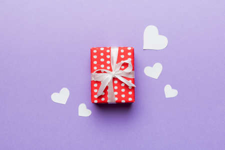 Valentine day composition: red gift box with bow and heart. Christmas present. View from above. Space for text. Holday greeting card.の写真素材