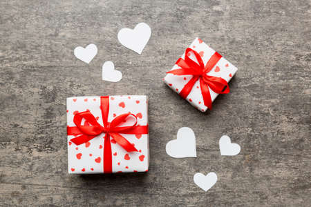 Valentine day composition Background: red gift box with bow and heart. Christmas present. View from above. Holday greeting card.の写真素材