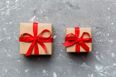 Valentine day composition Background: red gift box with bow and heart. Christmas present. View from above. Holday greeting card.の写真素材