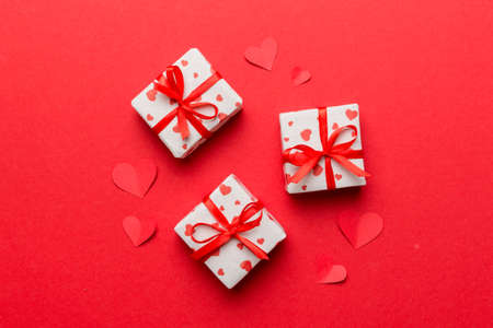 Valentine day composition Background: red gift box with bow and heart. Christmas present. View from above. Holday greeting card.の写真素材