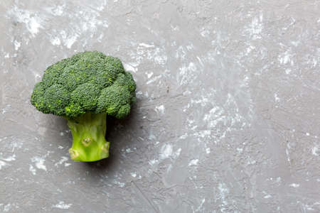 Top view fresh green broccoli vegetable on Colored background. Broccoli cabbage head Healthy or vegetarian food concept. Flat lay. Copy space.の写真素材