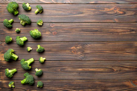 Top view fresh green broccoli vegetable on Colored background. Broccoli cabbage head Healthy or vegetarian food concept. Flat lay. Copy space.の写真素材