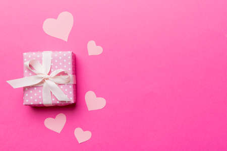 Valentine day composition: red gift box with bow and heart. Christmas present. View from above. Space for text. Holday greeting card.の写真素材