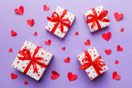 Valentine day composition Background: red gift box with bow and heart. Christmas present. View from above. Holday greeting card.の写真素材