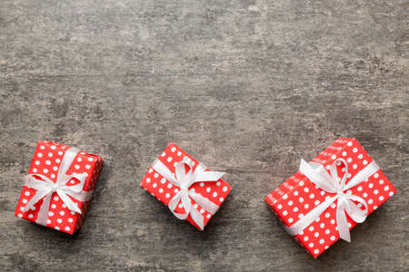 Valentine day composition: red gift box with bow and heart. Christmas present. View from above....