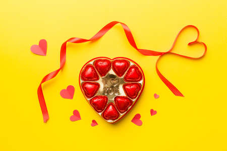 Delicious chocolate pralines in red box for Valentine's Day. Heart shaped box of chocolates top view with copy space.の写真素材
