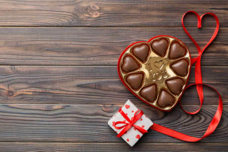 Delicious chocolate pralines in box for Valentine's Day. Heart shaped with gift box of chocolates top view with copy space.の写真素材