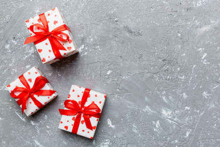 Valentine day composition: red gift box with bow and heart. Christmas present. View from above....