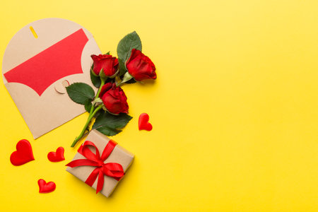 Valentine day composition with envelope, rose flower and red heart on table. Top view, flat lay, copy space Holiday concept.の写真素材