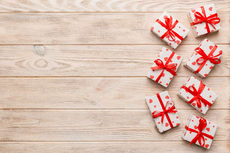 Valentine day composition: red gift box with bow and heart. Christmas present. View from above....