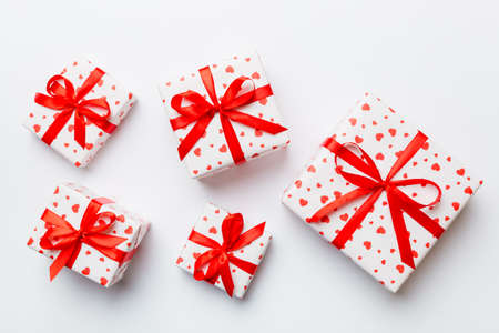 Valentine day composition Background: red gift box with bow and heart. Christmas present. View from...